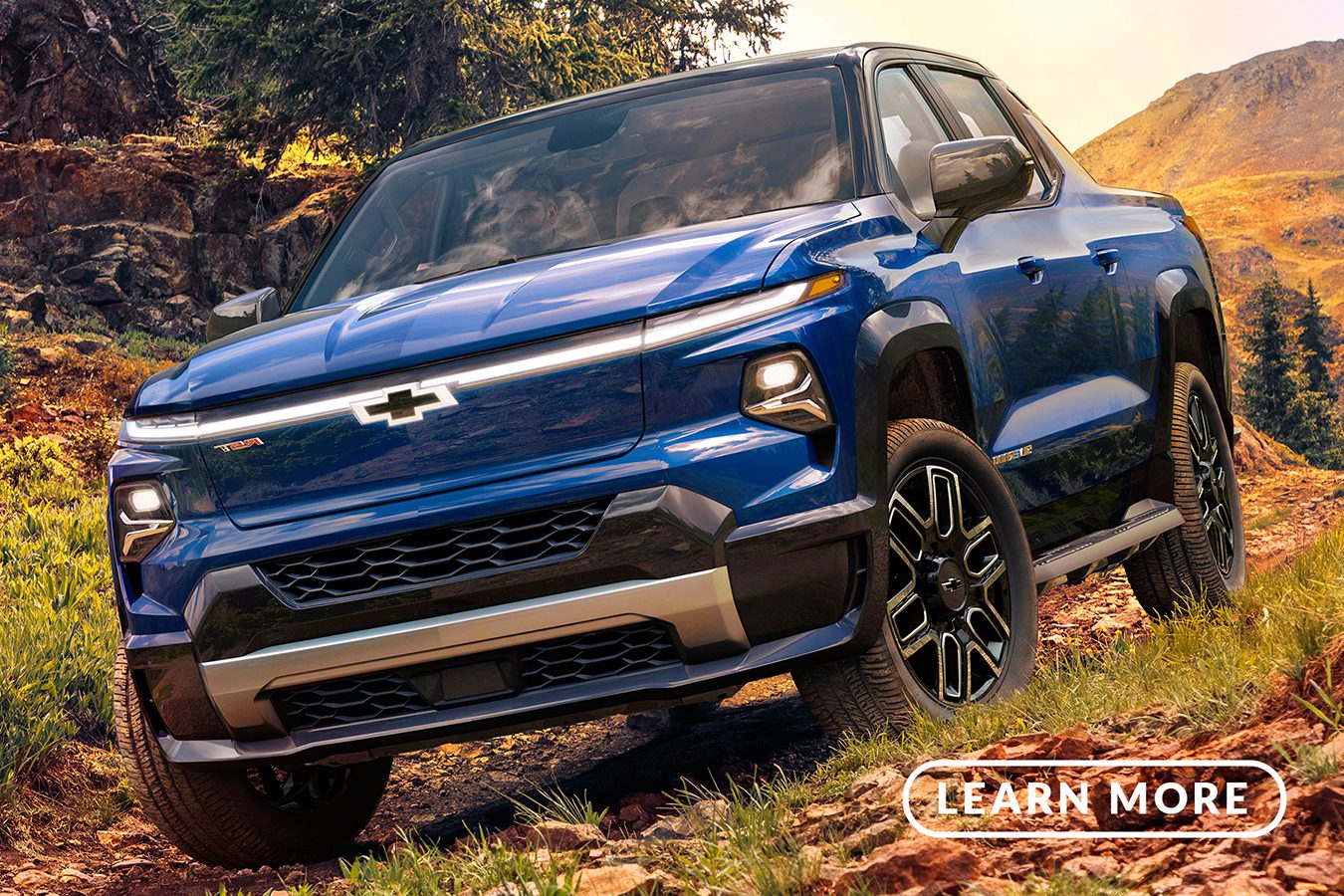 The 2020 chevrolet colorado is driving down a rocky trail.