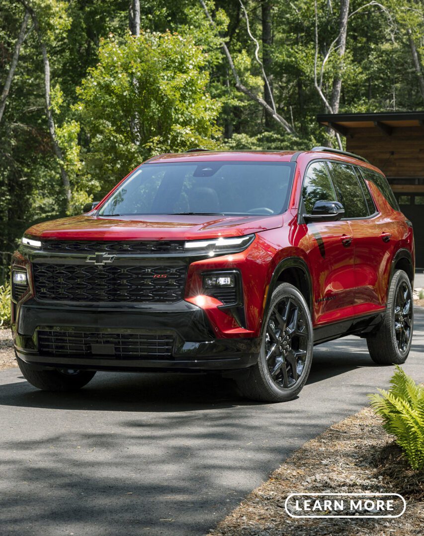 The red 2020 chevrolet trailblazer is parked in front of a house.