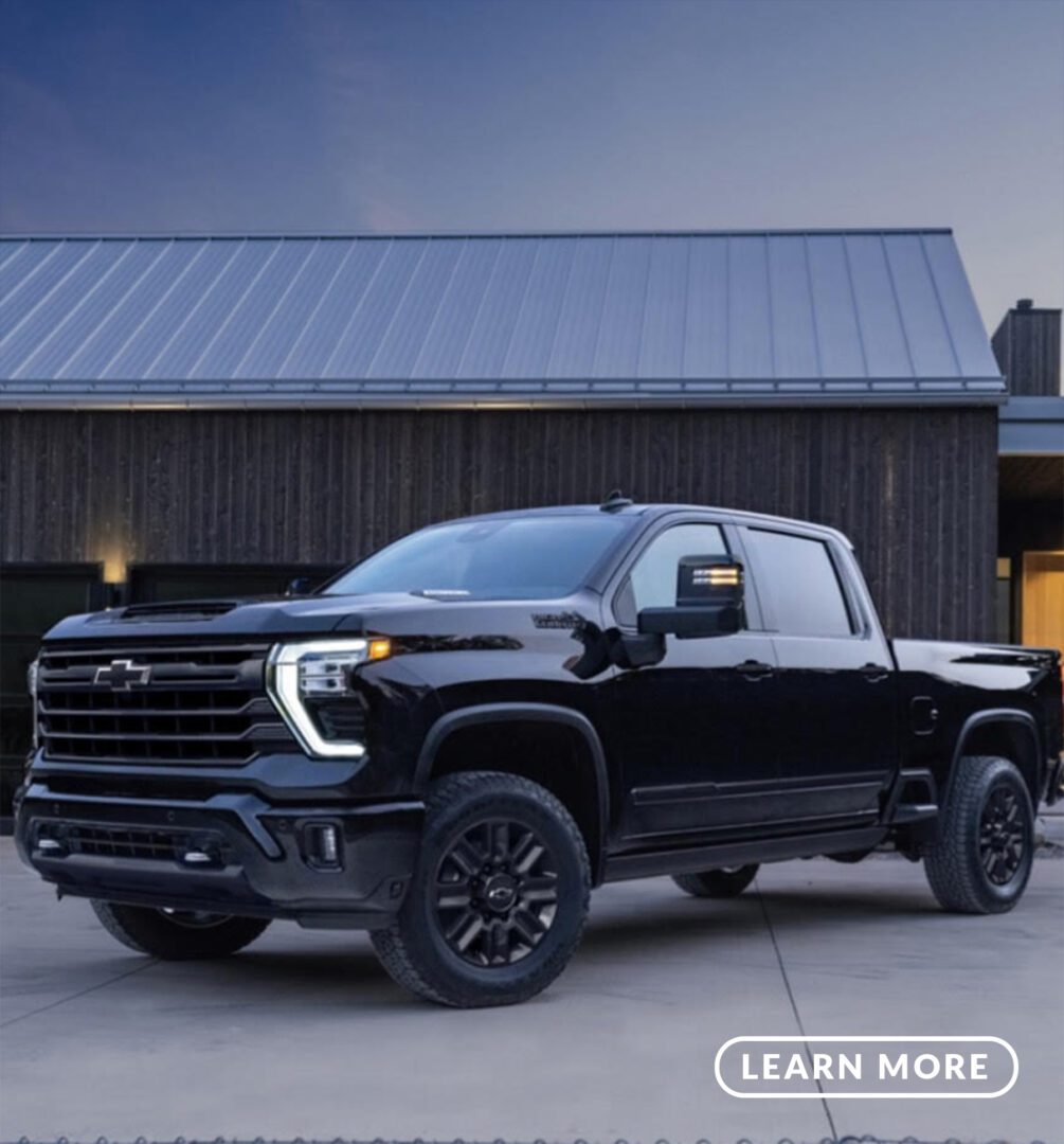 The black 2019 chevrolet silverado is parked in front of a house.