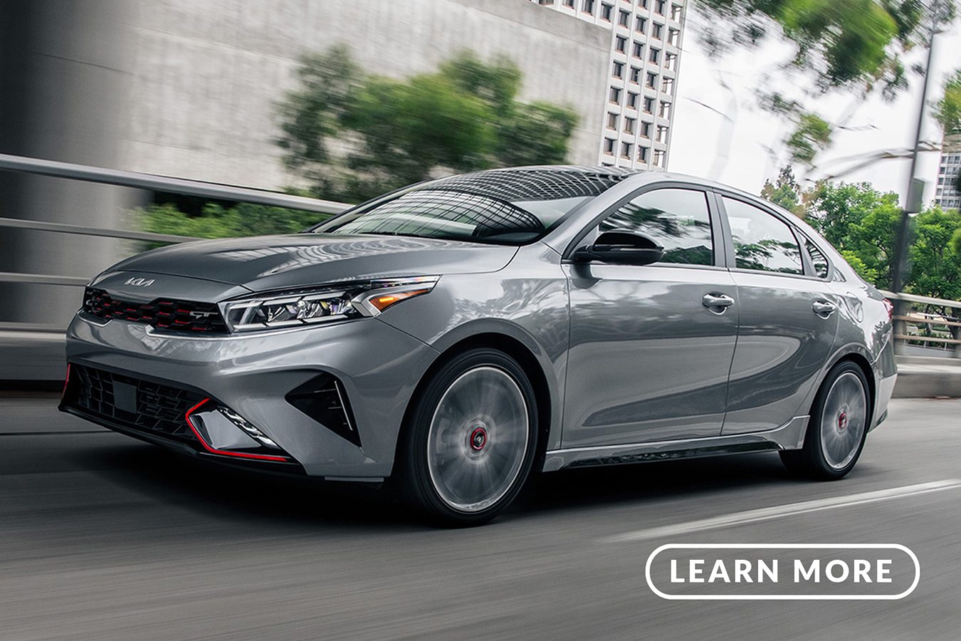 The 2019 kia forte is driving down a city street.