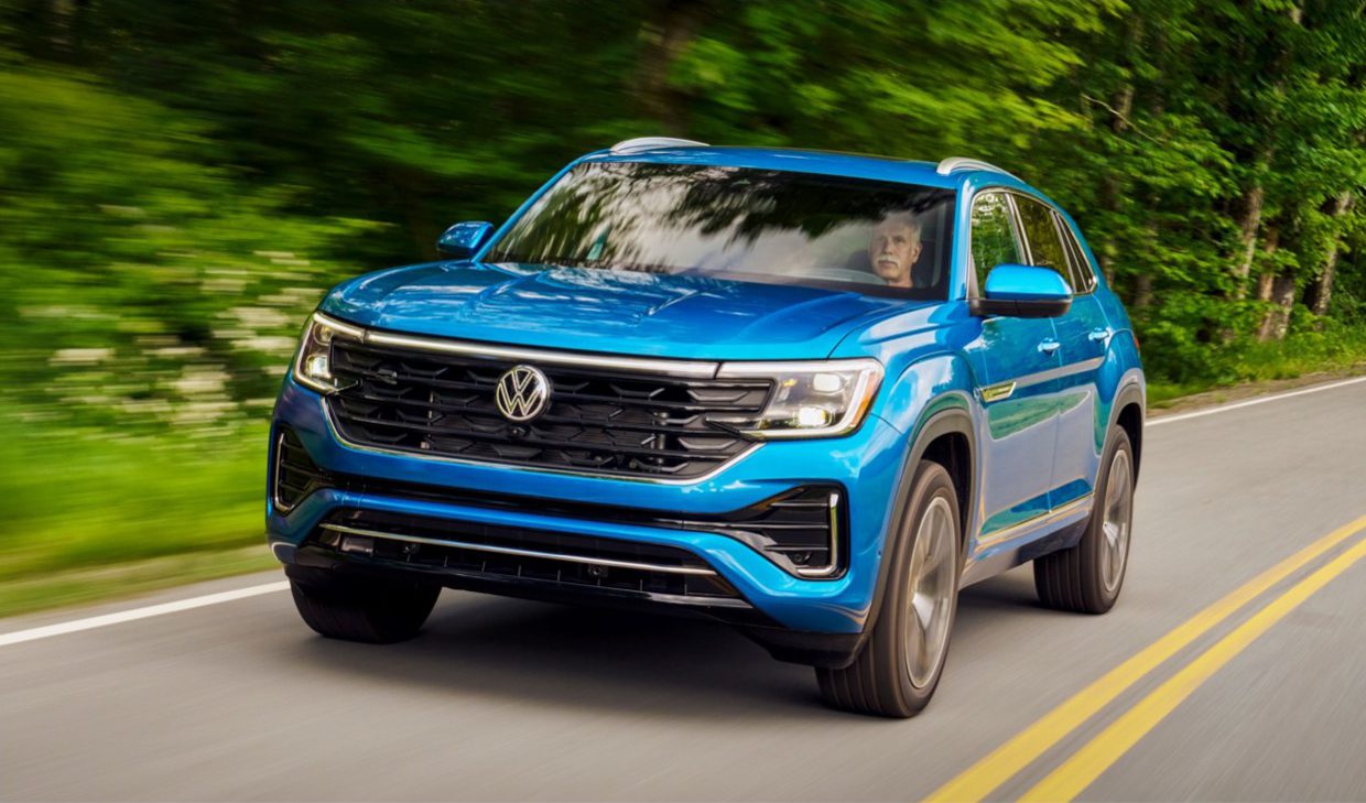 The 2020 volkswagen atlas is driving down a country road.