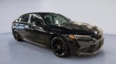 Black sedan in modern showroom