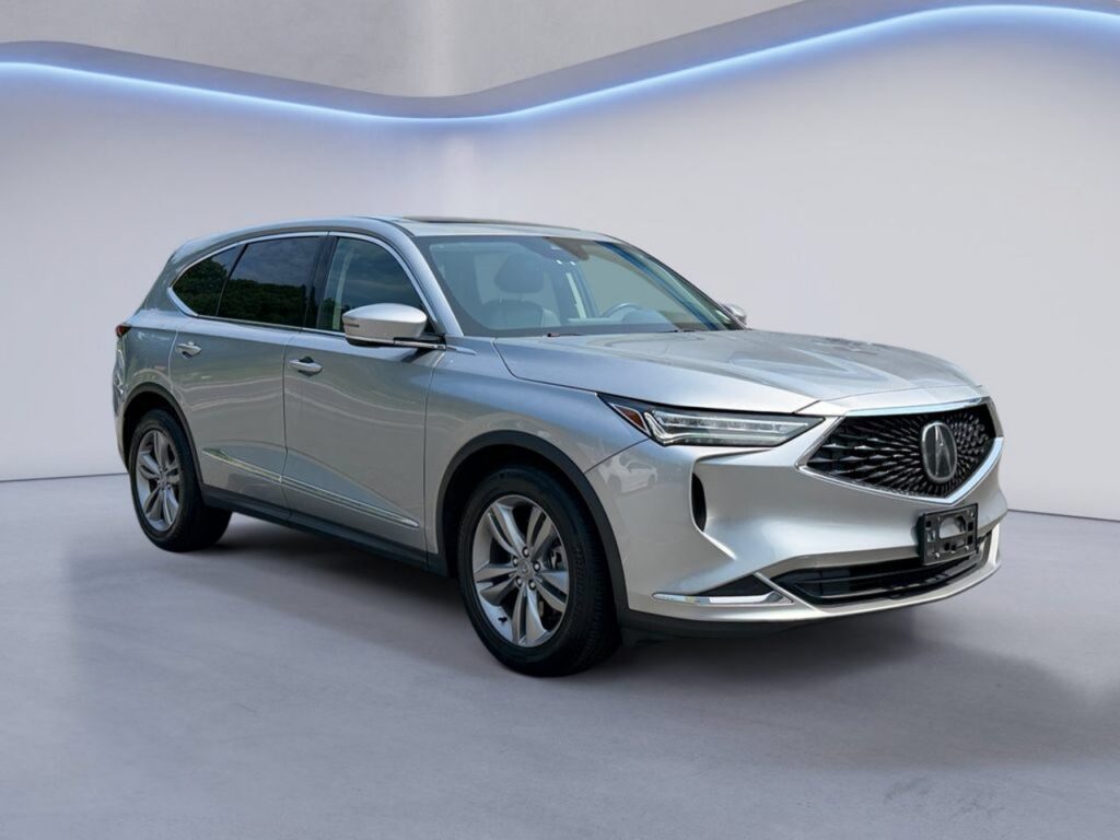 Silver Acura SUV in modern showroom