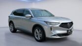 Silver Acura SUV in modern showroom