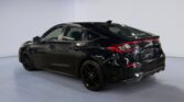 Black Honda Civic three-quarter rear view