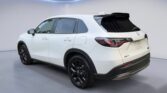 White compact SUV parked in modern showroom