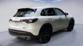 White crossover SUV rear three-quarter view