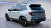 Light blue Honda Passport SUV rear view
