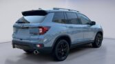 Light blue Honda SUV rear three-quarter view