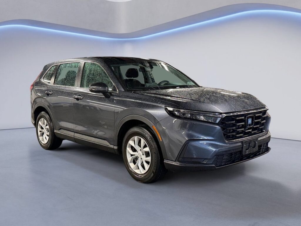 Gray Honda SUV in showroom with water droplets