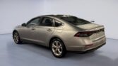 Silver sedan parked against white studio backdrop