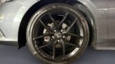 Black Honda alloy wheel on gray car