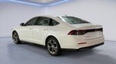 White four-door sedan in showroom