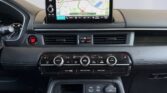 Car dashboard with navigation screen and climate controls