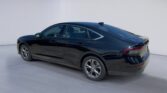 Black modern sedan in white studio